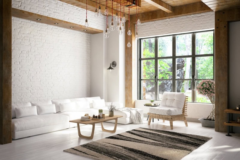 How Does Your Central Air Conditioner Cool Your Home? Photo of a modern home living room during the day with a window letting sunlight in.