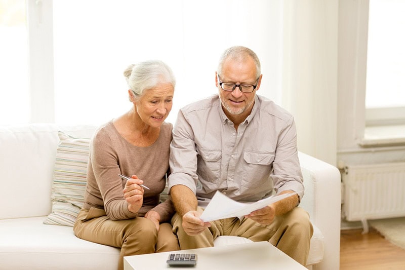 An older couple looking over papers together | What Does AFUE Mean? | Compare Furnace Efficiency | Maryville