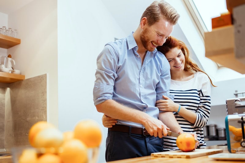 Happy couple making organic juice