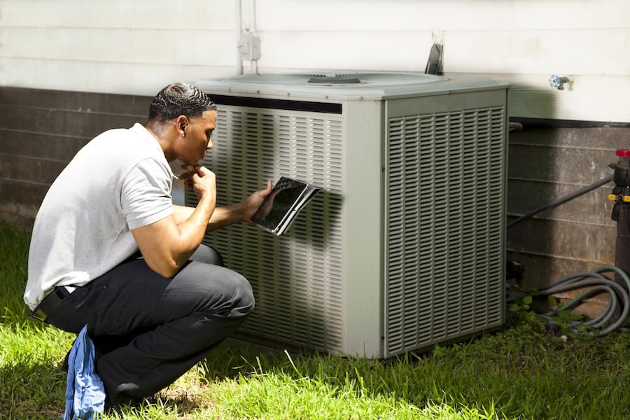 HVAC technician fixing an air conditioner in Greenback